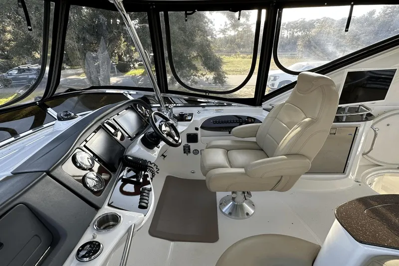  Yacht Photos Pics 2015 Meridian 441 Sedan helm with leather captain's chair and modern navigation controls.