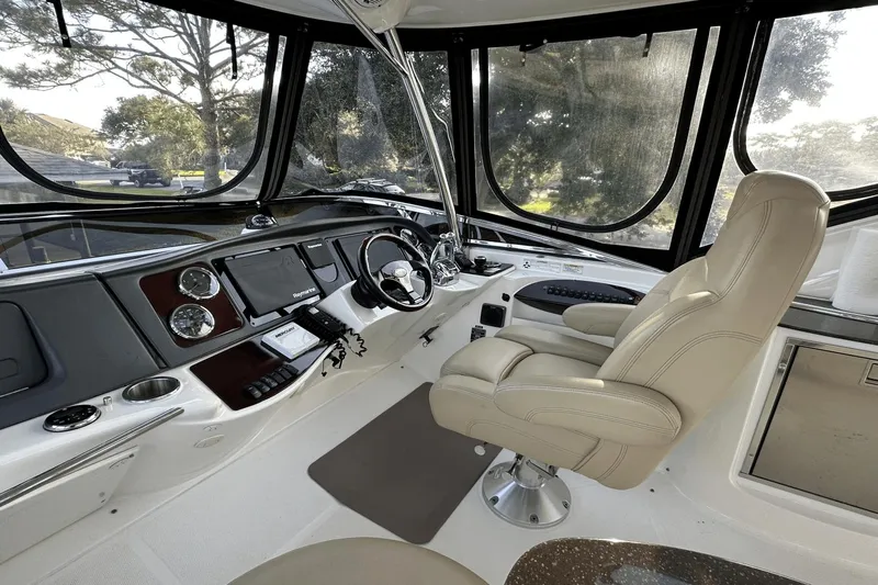  Yacht Photos Pics Interior of 2015 Meridian 441 Sedan yacht cockpit with steering wheel and control panel.