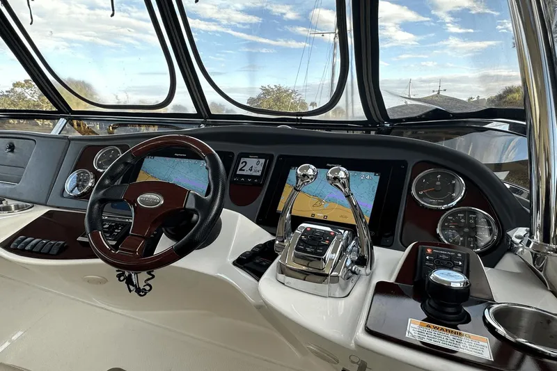  Yacht Photos Pics Cockpit of 2015 Meridian 441 Sedan with navigation screens and controls.