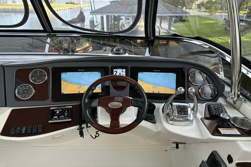  Yacht Photos Pics 2015 Meridian 441 Sedan helm with navigation screens and controls.