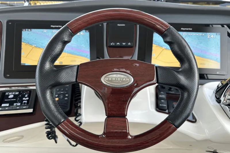  Yacht Photos Pics Steering wheel of 2015 Meridian 441 Sedan yacht with navigation screens.