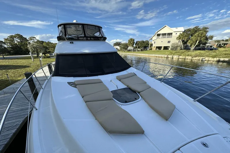  Yacht Photos Pics 2015 Meridian 441 Sedan yacht docked by a scenic waterfront with clear skies.
