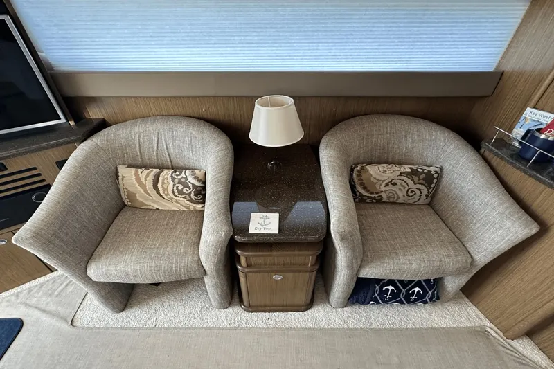 Yacht Photos Pics Interior of 2015 Meridian 441 Sedan with two armchairs and a small table.