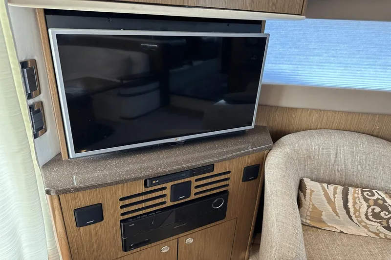  Yacht Photos Pics Entertainment system in 2015 Meridian 441 Sedan yacht interior with TV and seating area.