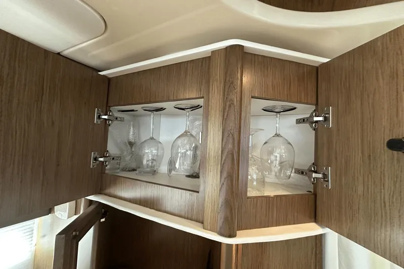  Yacht Photos Pics Wooden cabinet with glassware inside, aboard a 2015 Meridian 441 Sedan yacht.