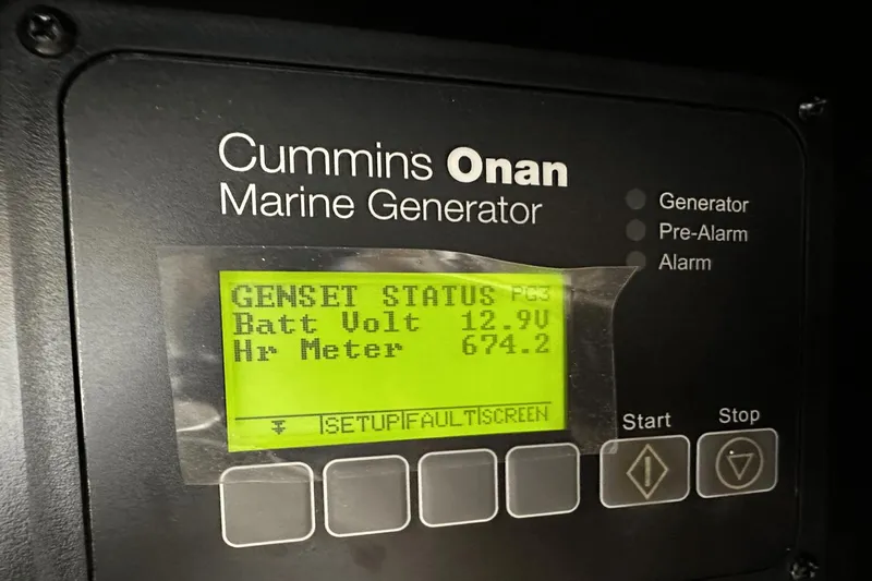  Yacht Photos Pics Cummins Onan marine generator display showing battery voltage and hour meter readings.