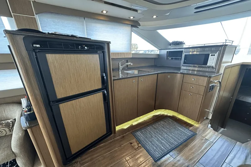  Yacht Photos Pics 2015 Meridian 441 Sedan yacht kitchen with modern appliances and wood cabinetry.