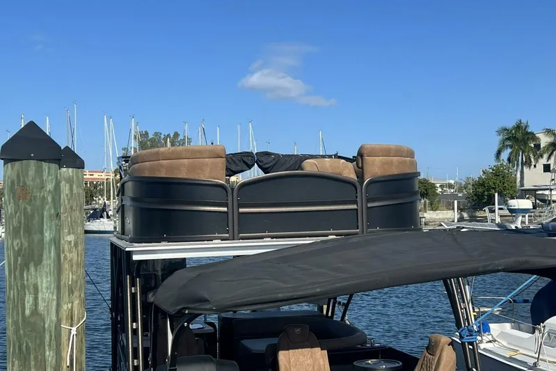  Yacht Photos Pics 2023 Premier 330 Escalante pontoon boat docked at marina, featuring upper deck seating.