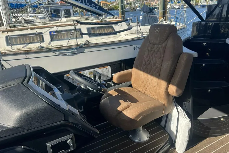  Yacht Photos Pics Captain's chair and helm of 2023 Premier 330 Escalante boat, docked at marina.