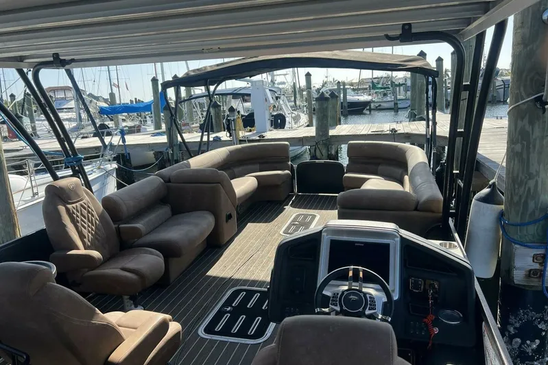  Yacht Photos Pics Luxurious 2023 Premier 330 Escalante pontoon boat interior with plush seating at marina.