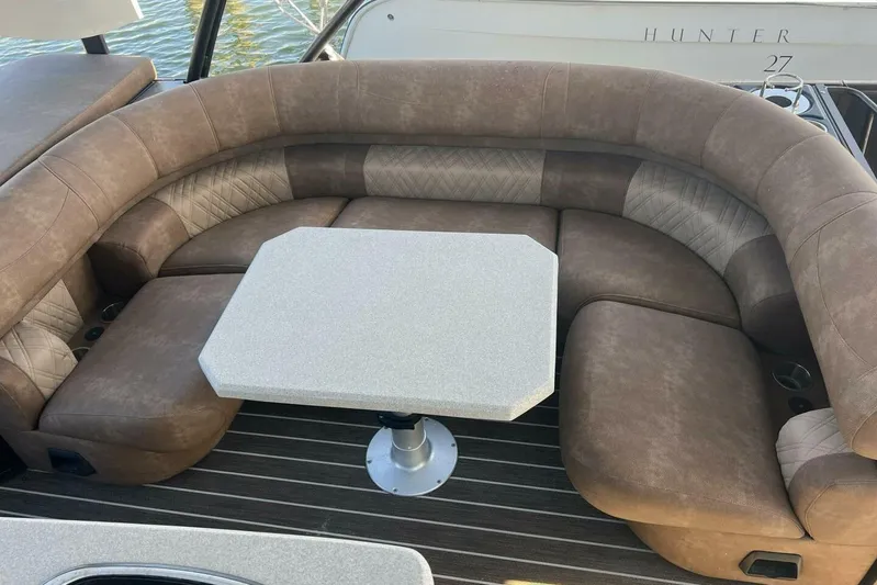  Yacht Photos Pics Luxurious seating area on 2023 Premier 330 Escalante boat with cushioned seats and table.