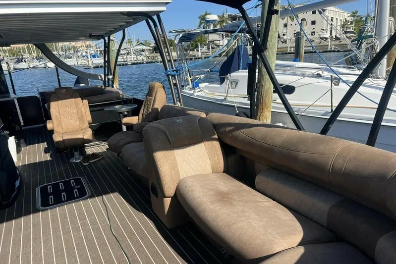  Yacht Photos Pics 2023 Premier 330 Escalante boat interior with luxurious seating at a marina.