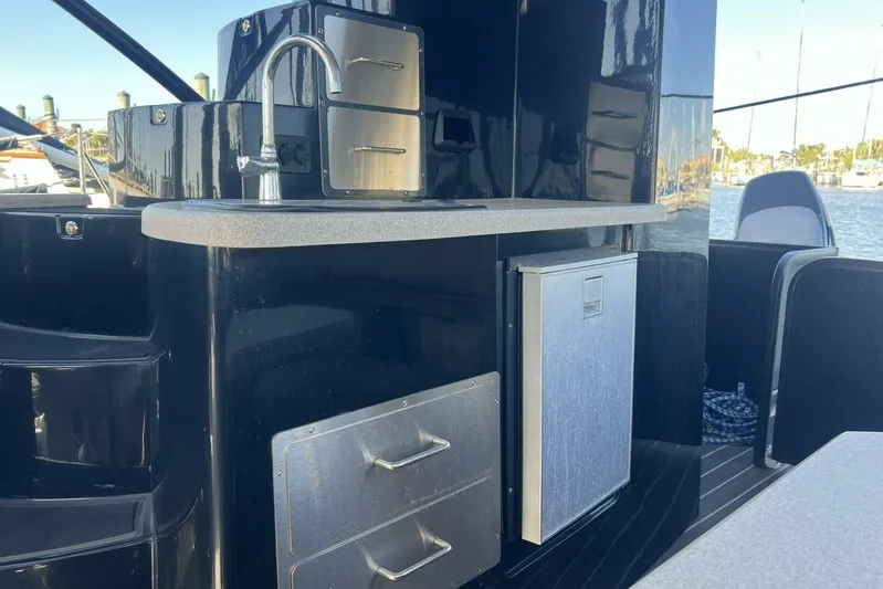  Yacht Photos Pics Outdoor kitchenette on 2023 Premier 330 Escalante boat with sink and storage drawers.