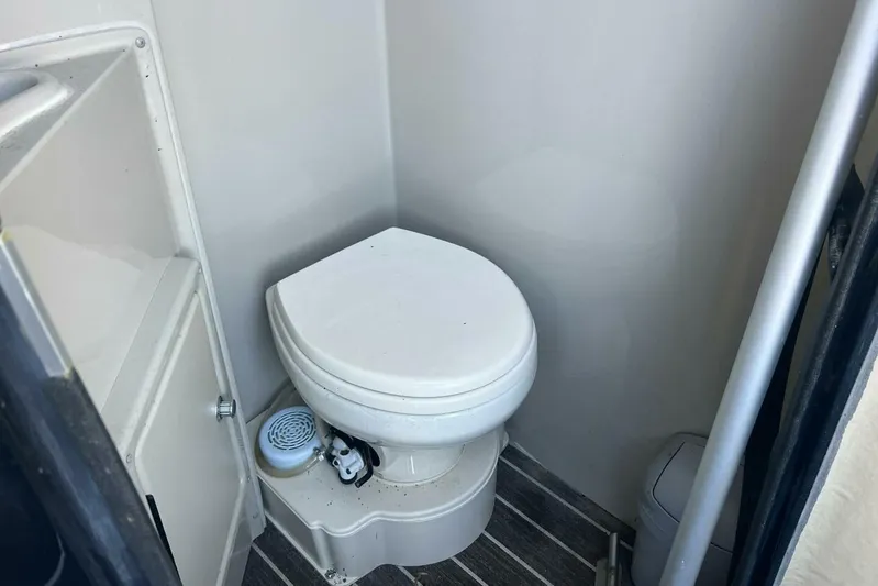  Yacht Photos Pics 2023 Premier 330 Escalante boat bathroom with compact toilet and storage.
