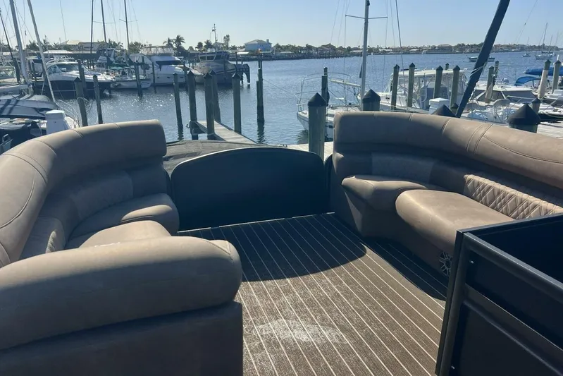  Yacht Photos Pics 2023 Premier 330 Escalante boat interior with plush seating at a marina.