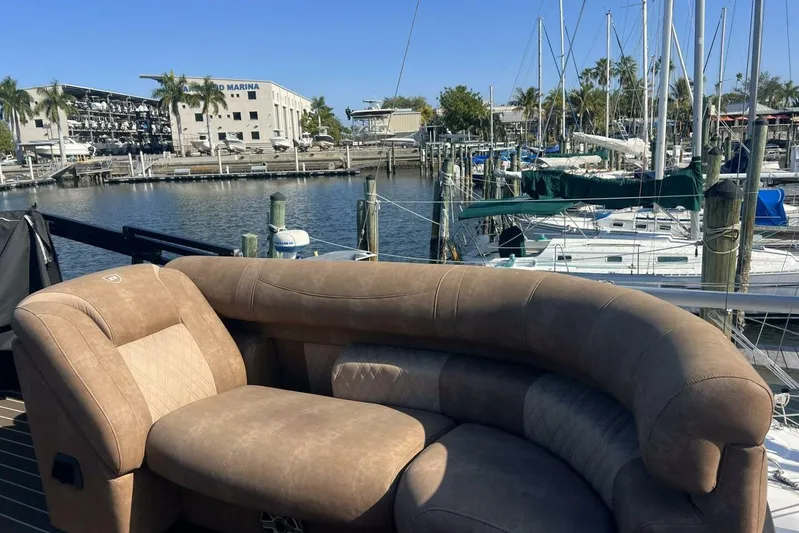  Yacht Photos Pics Luxurious seating on 2023 Premier 330 Escalante boat at marina with sailboats.