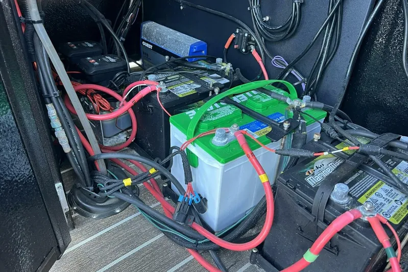  Yacht Photos Pics 2023 Premier 330 Escalante battery compartment with multiple connected batteries and cables.