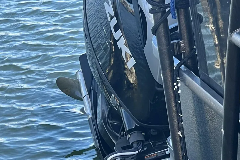  Yacht Photos Pics Outboard motor on 2023 Premier 330 Escalante boat, near water surface.