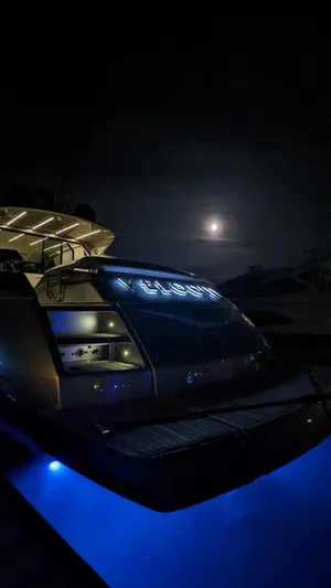  Yacht Photos Pics 2015 Pershing 62' yacht illuminated at night with blue underwater lights.