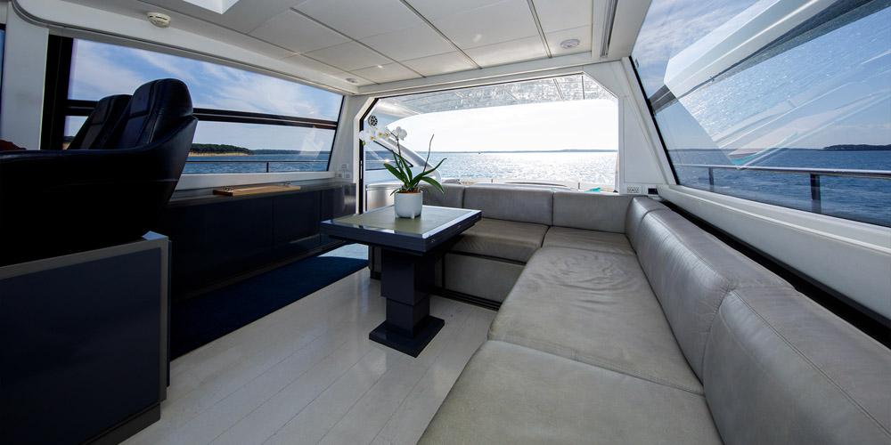 Luxurious interior of 2015 Pershing 62' yacht with panoramic ocean view.