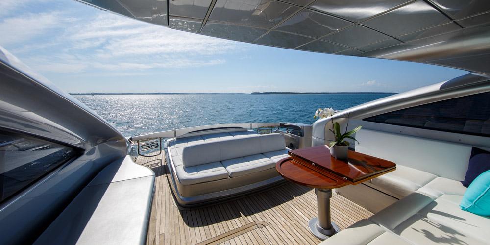 Luxurious 2015 Pershing 62' yacht deck with ocean view and elegant seating area.