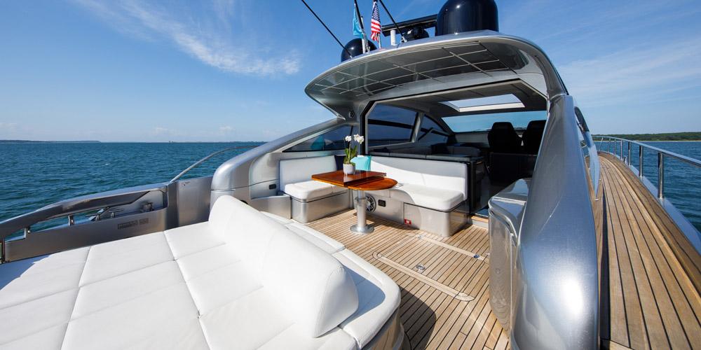 Luxurious 2015 Pershing 62' yacht with spacious deck and elegant seating on open water.