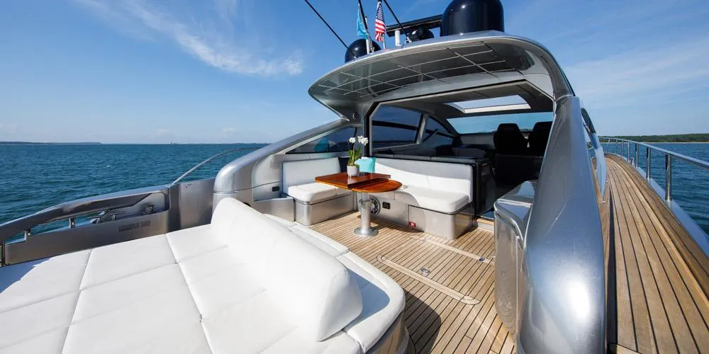 Luxurious 2015 Pershing 62' yacht with spacious deck and elegant seating on open water.