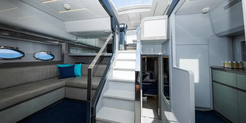  Yacht Photos Pics Luxurious interior of 2015 Pershing 62' yacht with modern seating and elegant staircase.