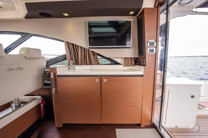 Sol E Mar IV Yacht Photos Pics 2015 Sea Ray 510 Sundancer interior with TV, cabinetry, and water view.