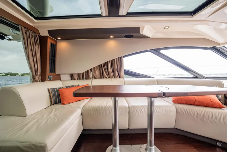 Sol E Mar IV Yacht Photos Pics Luxurious interior of 2015 Sea Ray 510 Sundancer yacht with plush seating and elegant table.