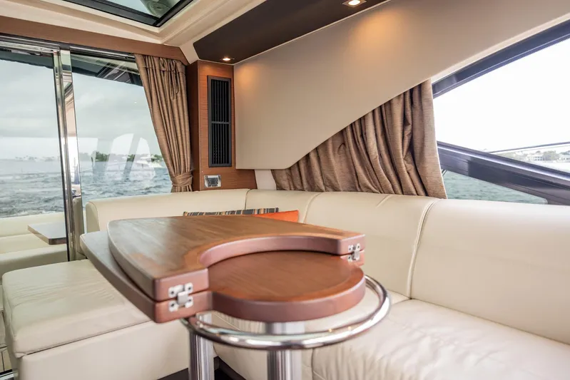 Sol E Mar IV Yacht Photos Pics Luxurious interior of 2015 Sea Ray 510 Sundancer yacht with elegant seating and wooden table.