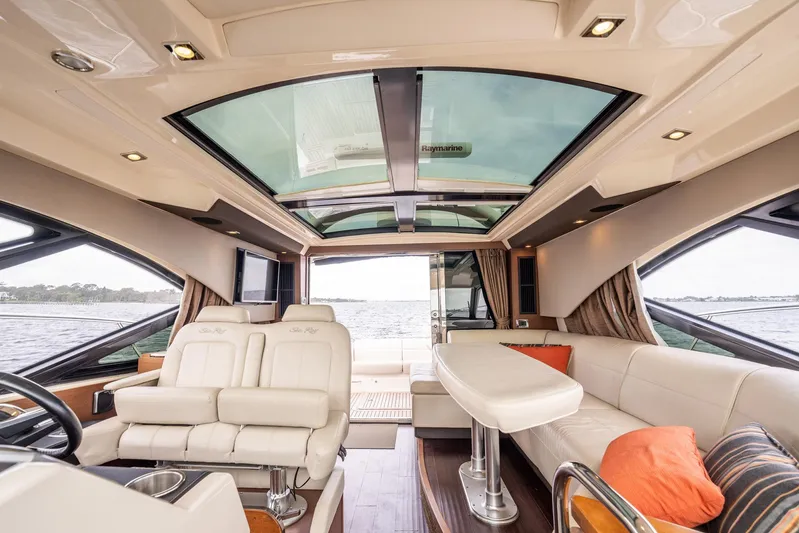 Sol E Mar IV Yacht Photos Pics Luxurious interior of 2015 Sea Ray 510 Sundancer yacht with plush seating and panoramic windows.