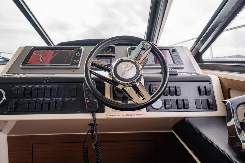 Sol E Mar IV Yacht Photos Pics Helm of 2015 Sea Ray 510 Sundancer with navigation controls and steering wheel.