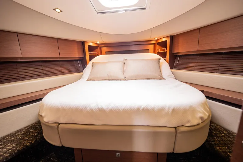 Sol E Mar IV Yacht Photos Pics Luxurious bedroom interior of 2015 Sea Ray 510 Sundancer yacht with elegant wood finishes.
