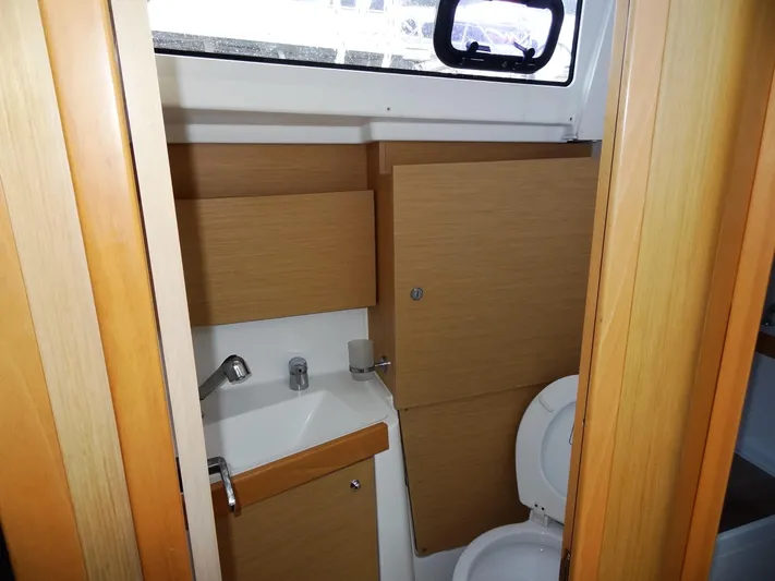 America Yacht Photos Pics Beneteau Oceanis 38 2018 model bathroom with sink, toilet, and wooden cabinetry.