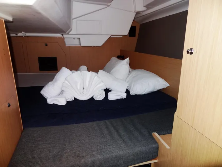 America Yacht Photos Pics Beneteau Oceanis 38 2018 cabin with neatly arranged towels and pillows on the bed.