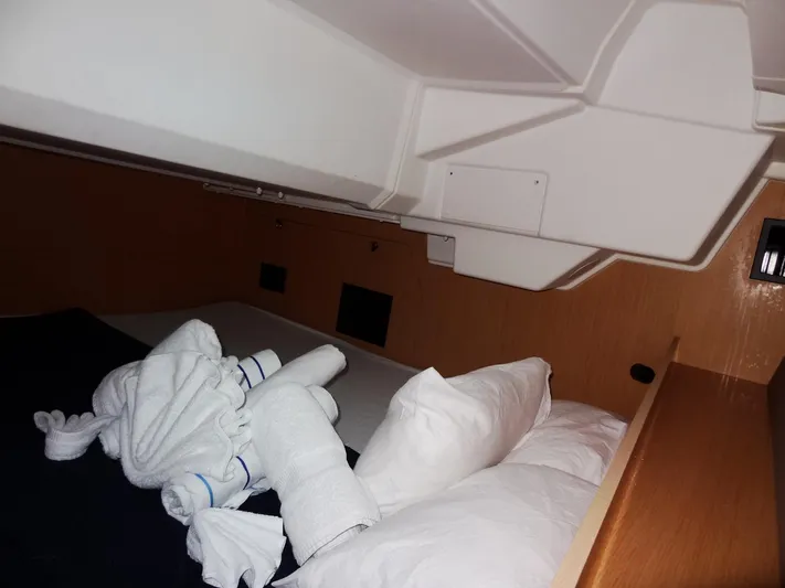 America Yacht Photos Pics Interior cabin of 2018 Beneteau Oceanis 38 sailboat with bed and towels.