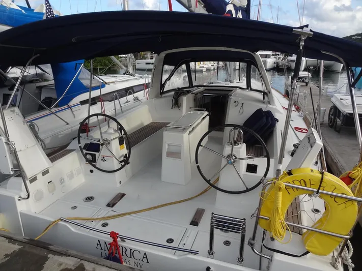 America Yacht Photos Pics 2018 Beneteau Oceanis 38 sailboat with dual steering wheels docked at marina.