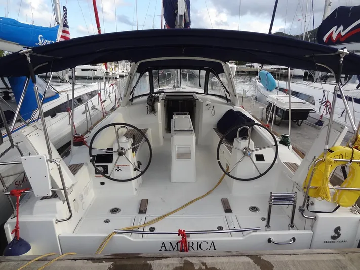 America Yacht Photos Pics 2018 Beneteau Oceanis 38 sailboat docked, featuring dual steering wheels and spacious cockpit.