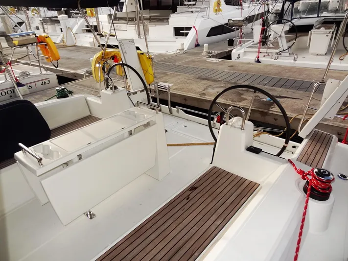 America Yacht Photos Pics 2018 Beneteau Oceanis 38 sailboat cockpit with dual steering wheels docked at marina.