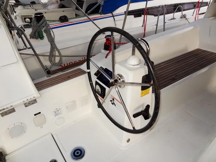 America Yacht Photos Pics 2018 Beneteau Oceanis 38 sailboat cockpit with steering wheel and control panel.