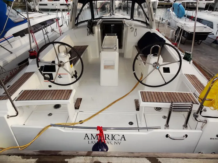 America Yacht Photos Pics 2018 Beneteau Oceanis 38 sailboat cockpit with dual steering wheels docked at marina.