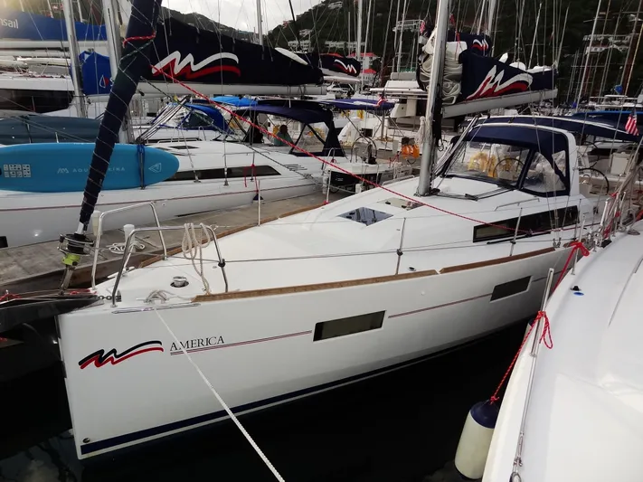 America Yacht Photos Pics 2018 Beneteau Oceanis 38 sailboat docked in a marina.
