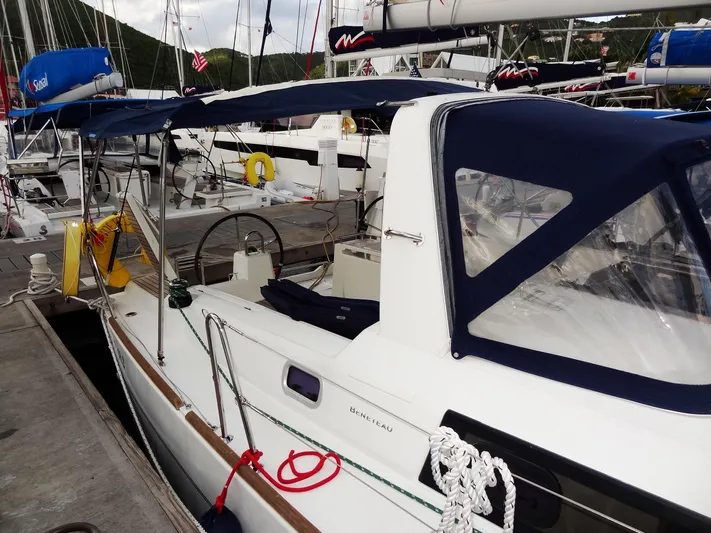America Yacht Photos Pics 2018 Beneteau Oceanis 38 sailboat docked at marina with blue canopy.