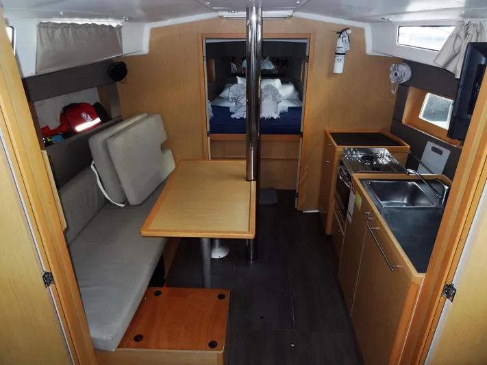 America Yacht Photos Pics Interior of 2018 Beneteau Oceanis 38 sailboat with kitchen, dining area, and sleeping quarters.