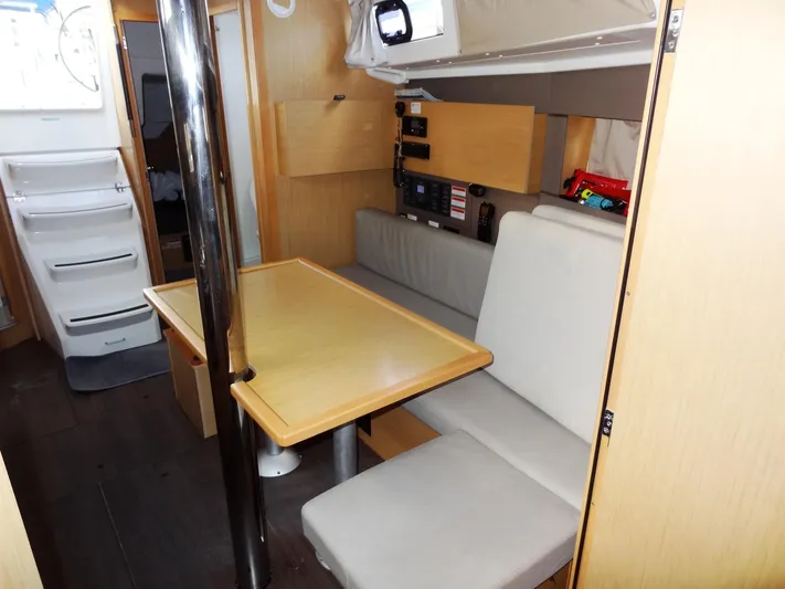 America Yacht Photos Pics Interior of 2018 Beneteau Oceanis 38 sailboat with dining area and navigation station.