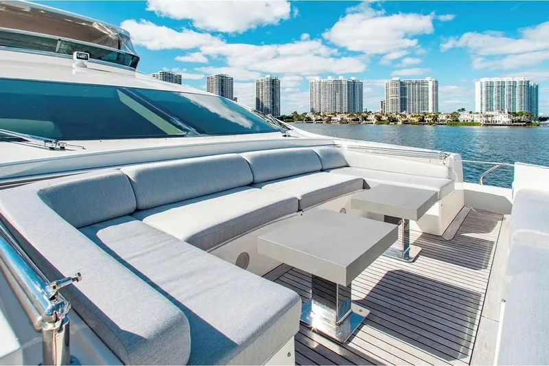 Bt2 Yacht Photos Pics Luxurious 2010 Azimut 95 yacht deck with modern seating, overlooking waterfront cityscape.