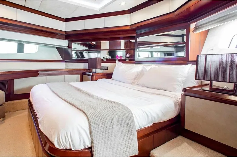 Bt2 Yacht Photos Pics Luxurious bedroom interior of 2010 Azimut 95 yacht with elegant wood finishes and plush bedding.