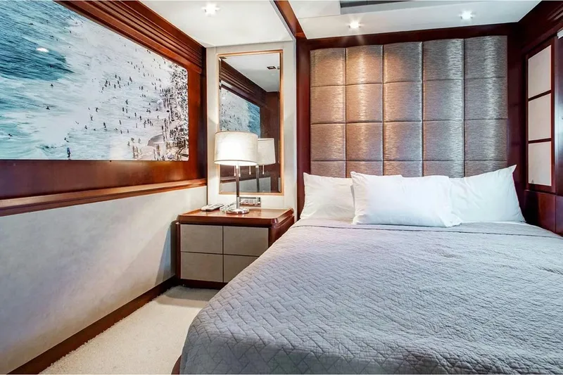 Bt2 Yacht Photos Pics Luxurious bedroom on 2010 Azimut 95 yacht with elegant decor and beach artwork.