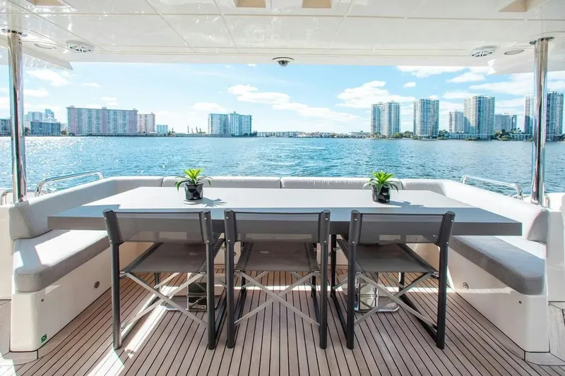 Bt2 Yacht Photos Pics Luxury Azimut 95 yacht deck with dining area, city skyline view, 2010 model.
